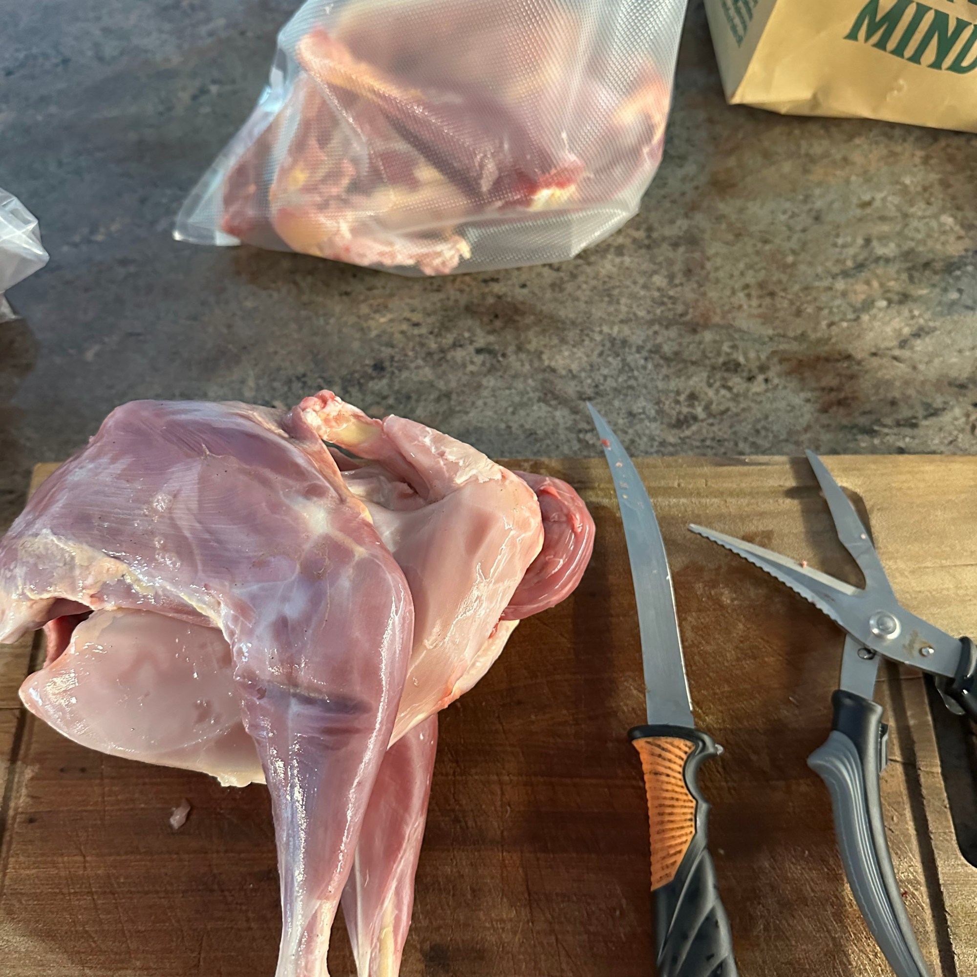 Skinless chicken on a butcher block
